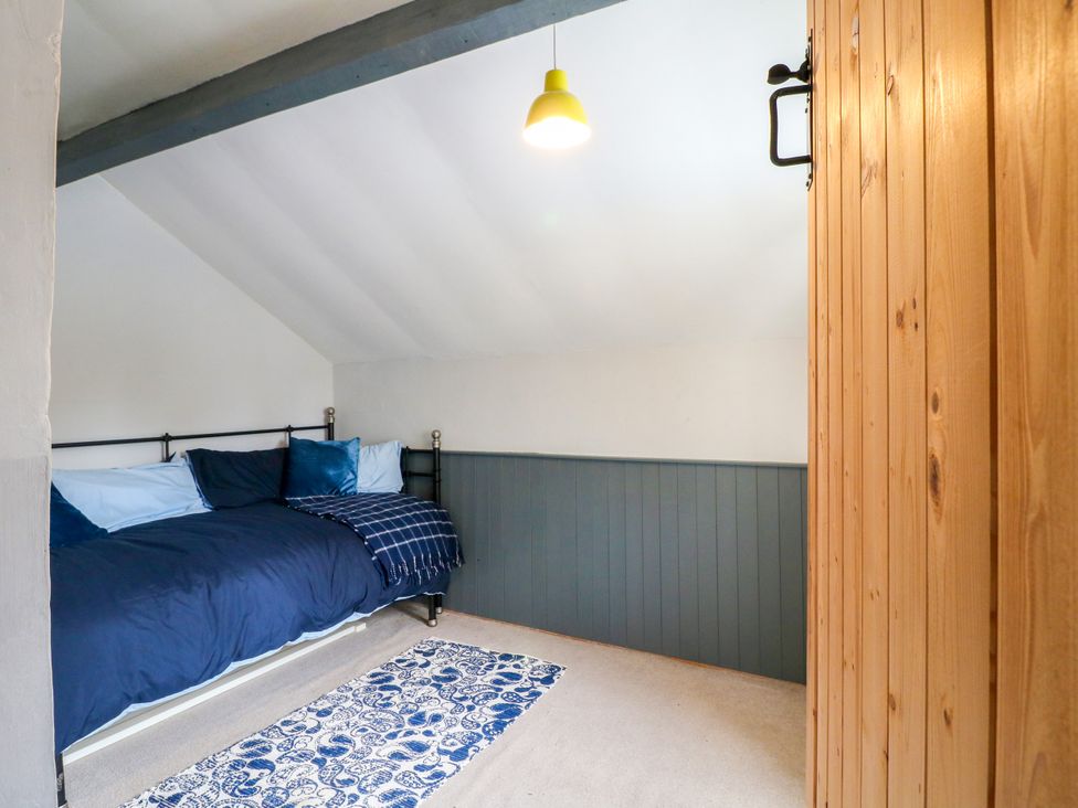 A bedroom with a bed and a rug at Next Door No. 4 in Coalville