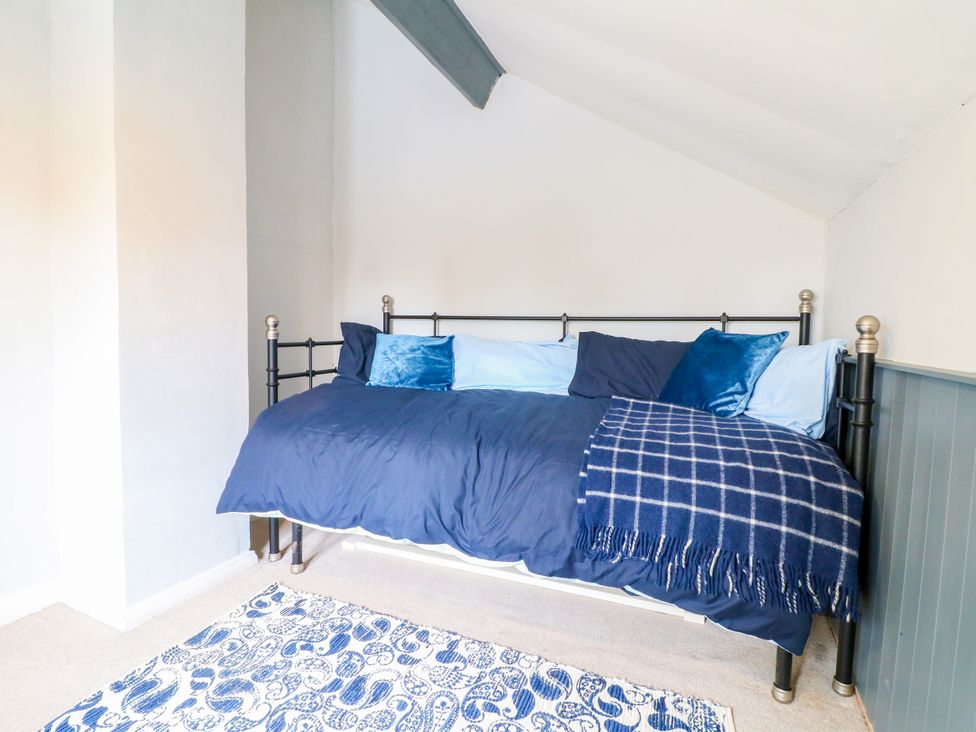 A bedroom with a bed covered in blue bedding at Next Door No. 4 in Coalville