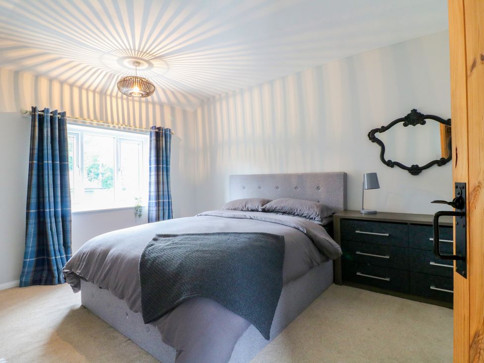 A bedroom with a bed and dresser at Next Door No. 4 in Coalville
