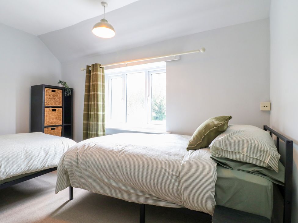 A bedroom with two beds and a window at Next Door No. 4 Coalville