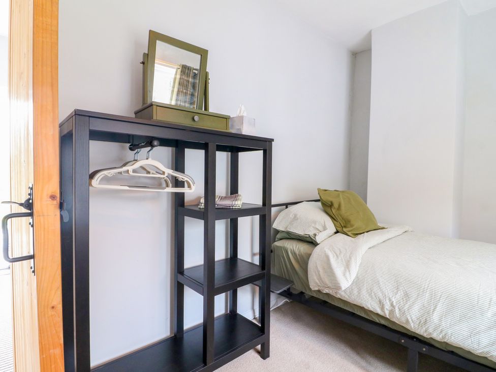 A bedroom with a bed and shelf at Next Door No. 4 in Coalville