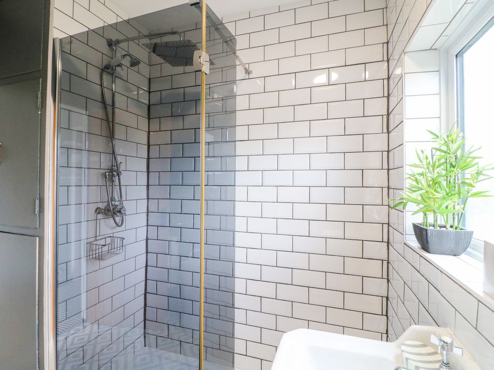 A bathroom with a shower and plant at Next Door No. 4 in Coalville