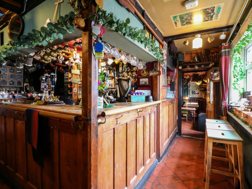 A pub interior with a bar and seating at Next Door No. 4 in Coalville