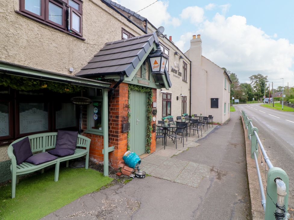 An outdoor seating area with tables and chairs at Next Door No. 4 in Coalville