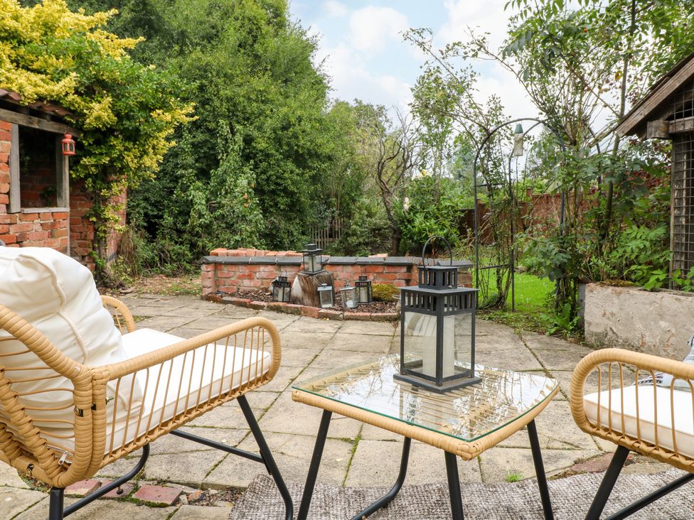 A garden area with chairs and a table at Next Door No. 4 Coalville