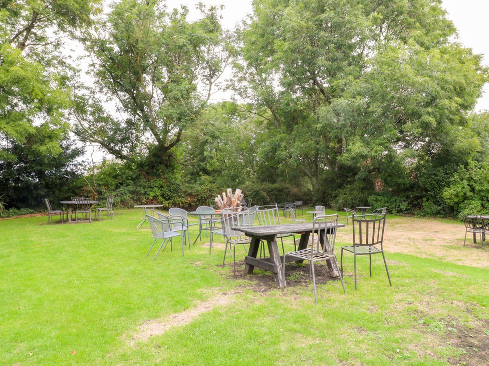 A garden with tables and chairs at Next Door No. 4 in Coalville