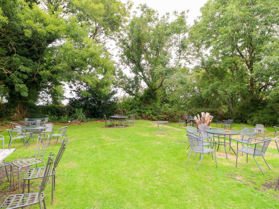 A garden with tables and chairs at Next Door No. 4 Coalville