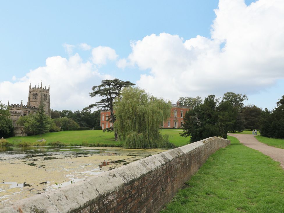 A church and large building next to a pond at Next Door No. 4 in Coalville
