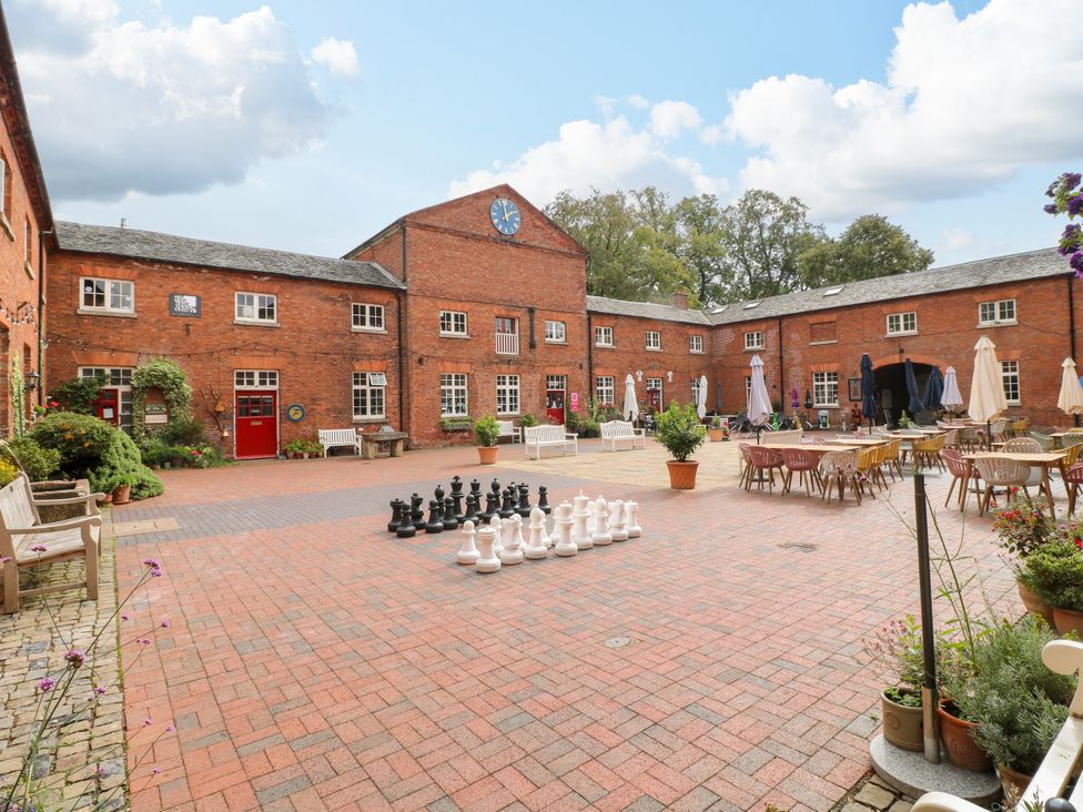 A courtyard with outdoor chess set and tables at Next Door No. 4 in Coalville