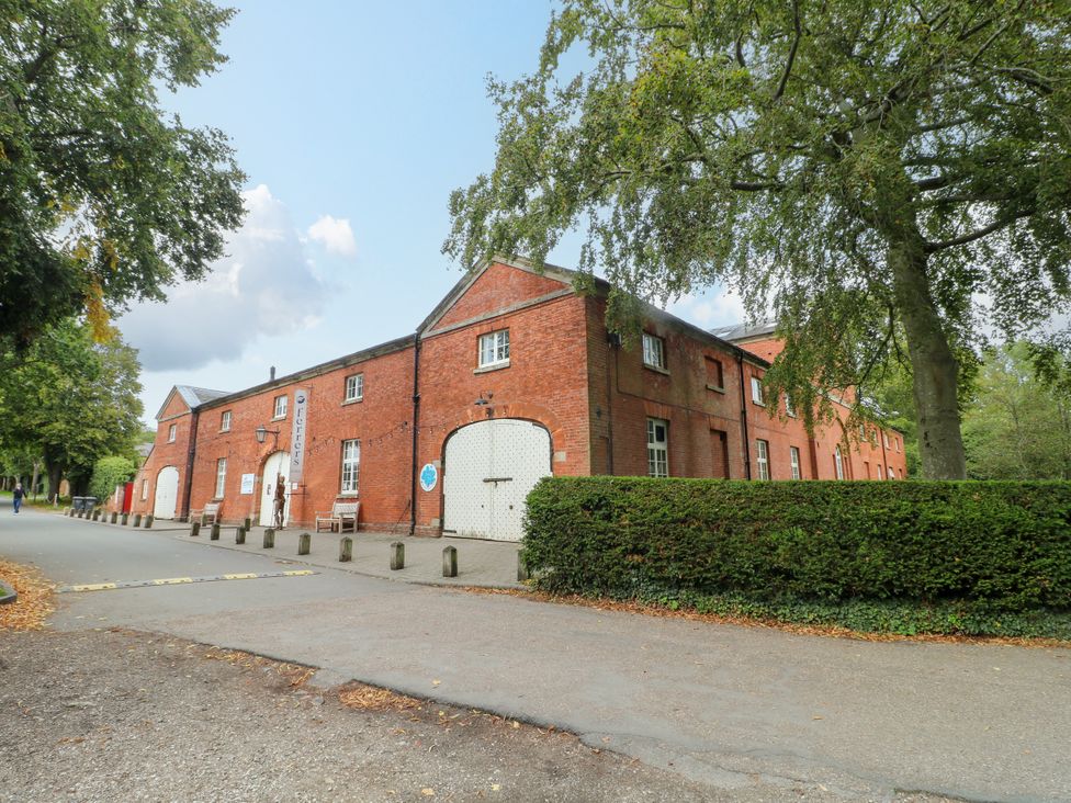 A building with a red brick facade and benches at Next Door No. 4 in Coalville