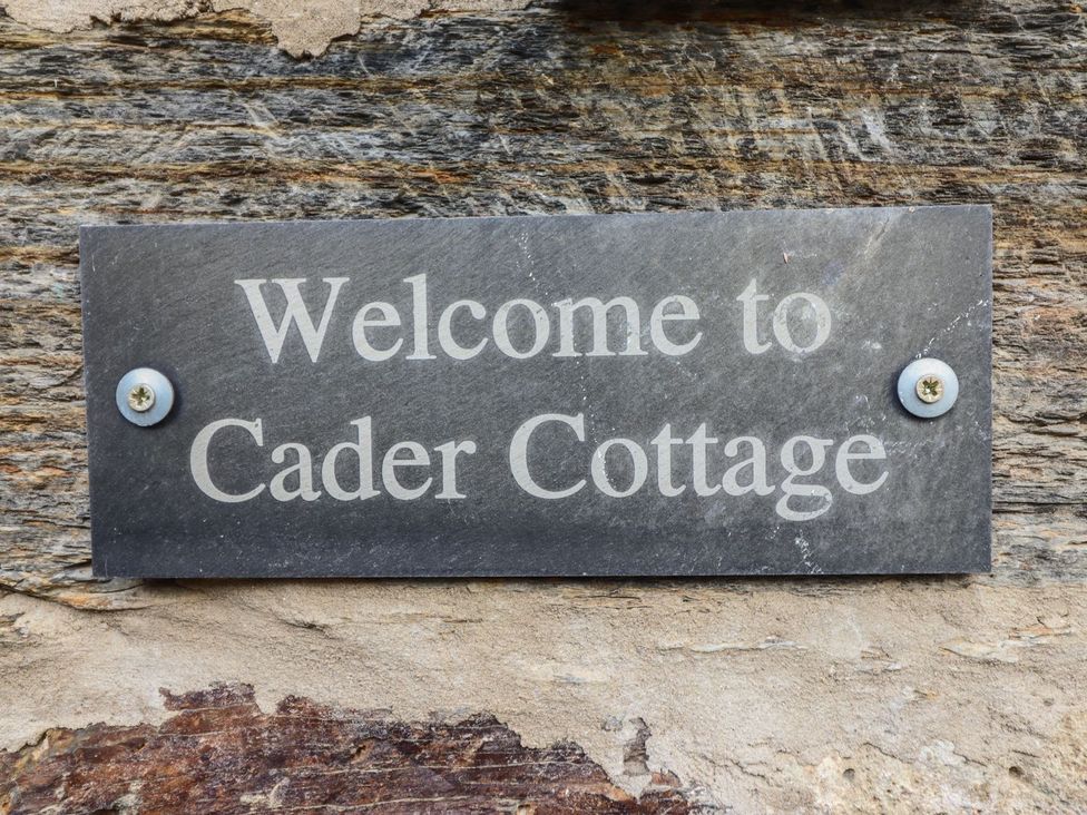 A welcome sign for Cader Cottage