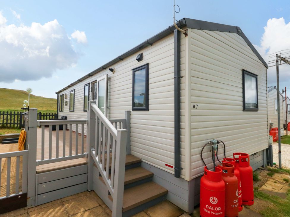 A caravan with steps and gas cylinders at Caravan A7 in Bridport