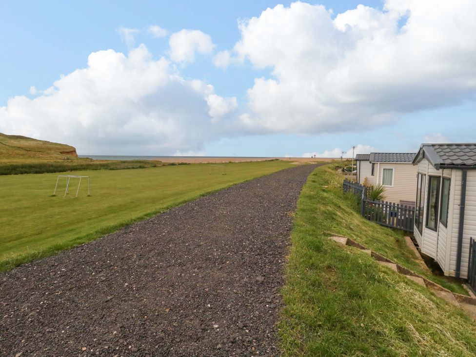 A path leading to mobile homes near the coast at Caravan A7 in Bridport