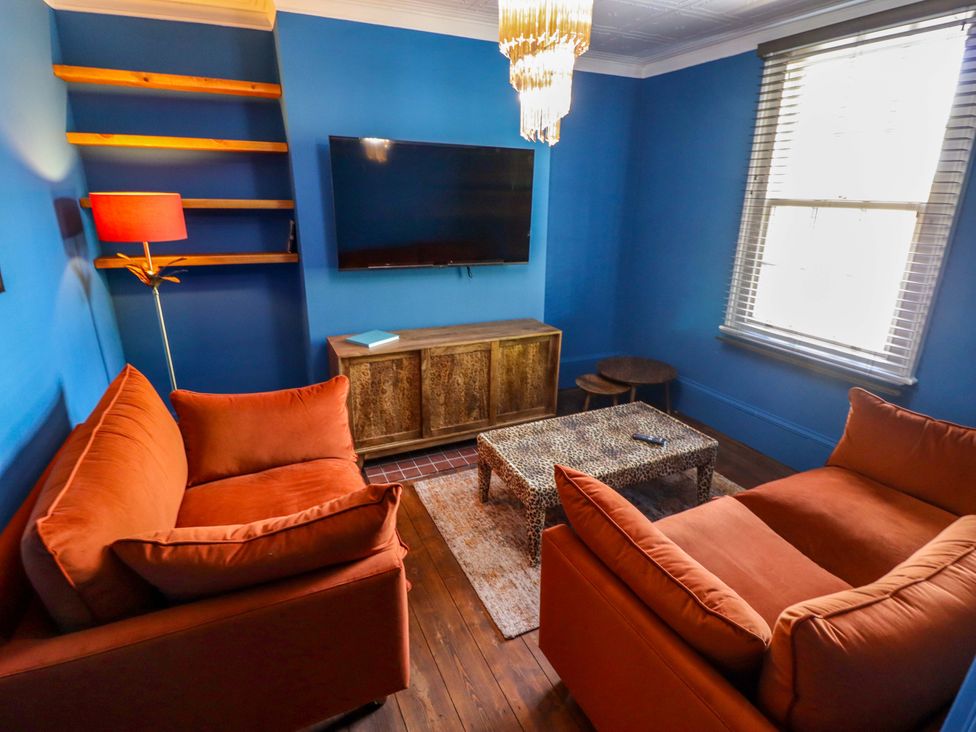 A living room with sofas and a television at 35 Wrawby Street in Brigg