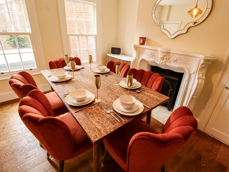 A dining room with a table set for dinner at 35 Wrawby Street Brigg
