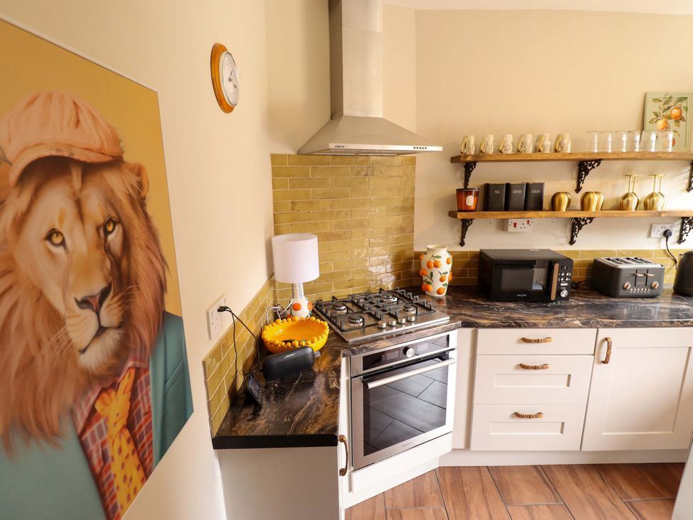 A kitchen with appliances and artwork at 35 Wrawby Street Brigg