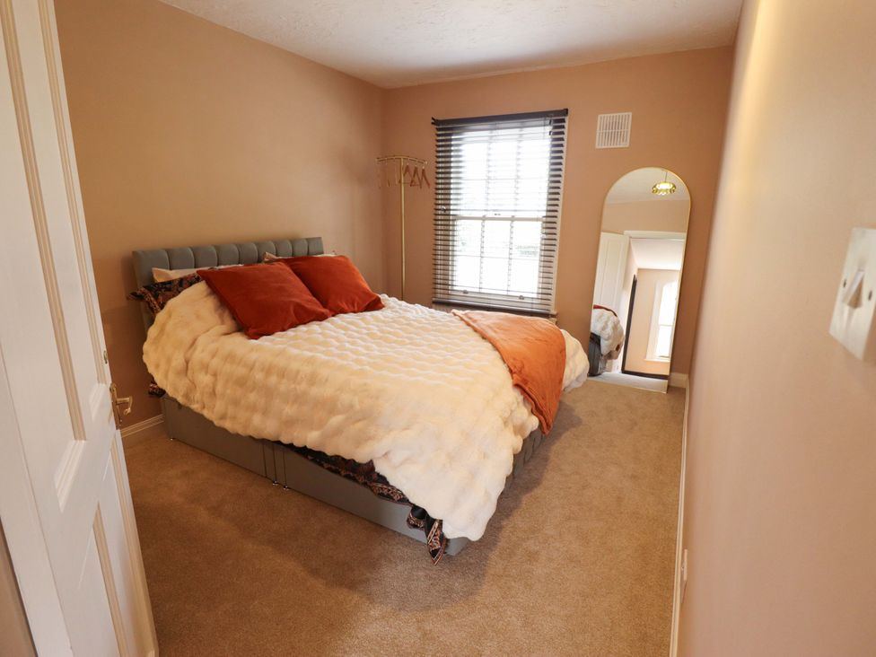 A bedroom with a bed and window at 35 Wrawby Street in Brigg