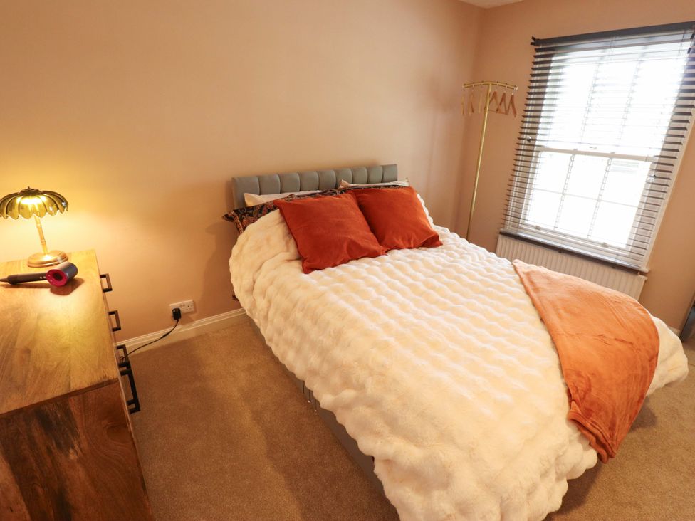 A bedroom with a bed and lamp at 35 Wrawby Street in Brigg