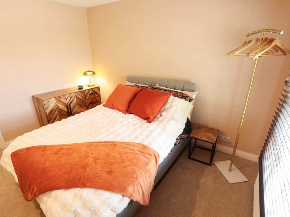 A bedroom with a bed and bedside table at 35 Wrawby Street in Brigg