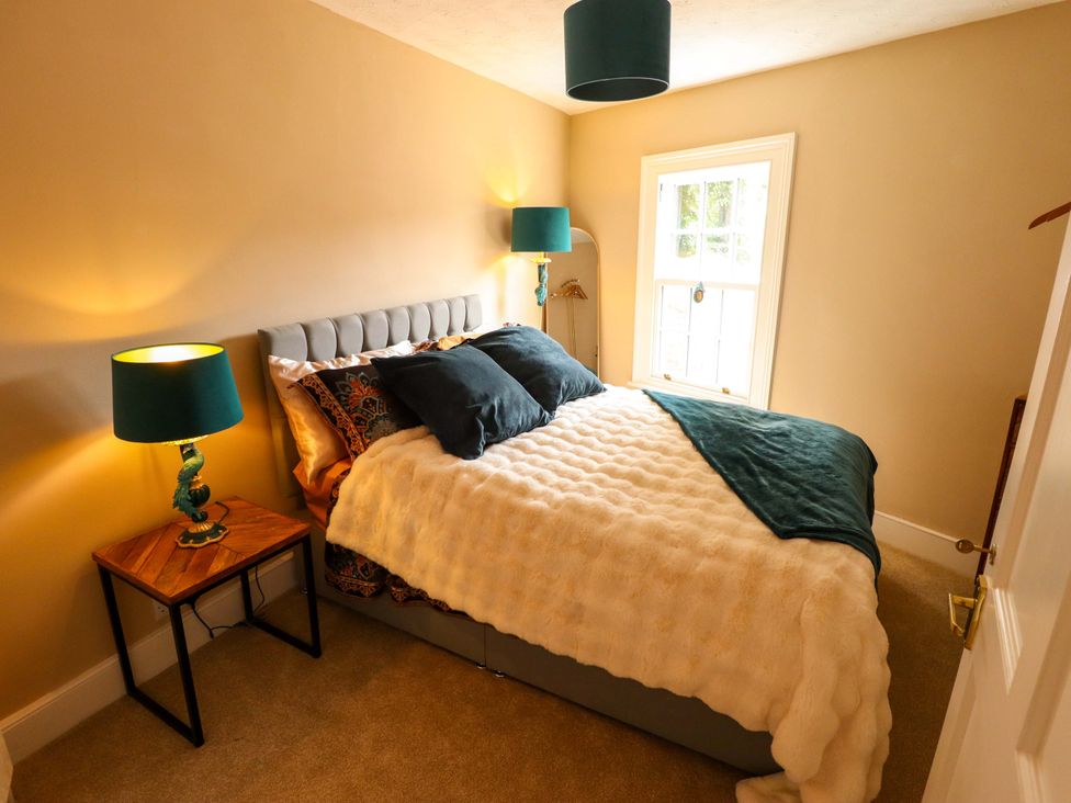 A bedroom with a bed and lamps at 35 Wrawby Street in Brigg