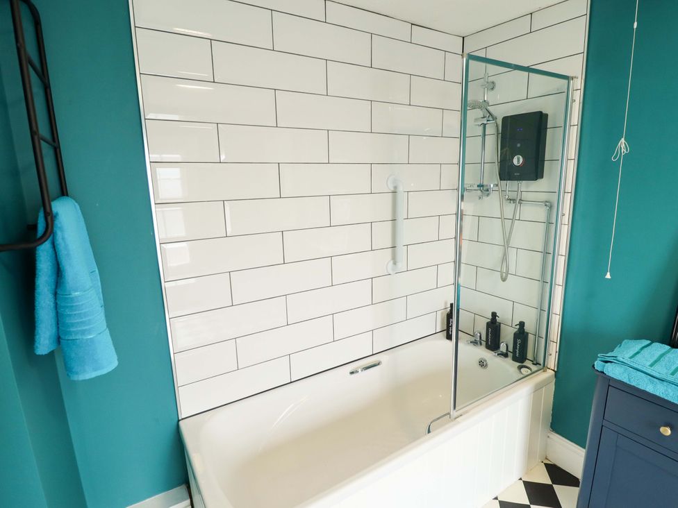A bathroom with a bathtub and shower at 35 Wrawby Street in Brigg