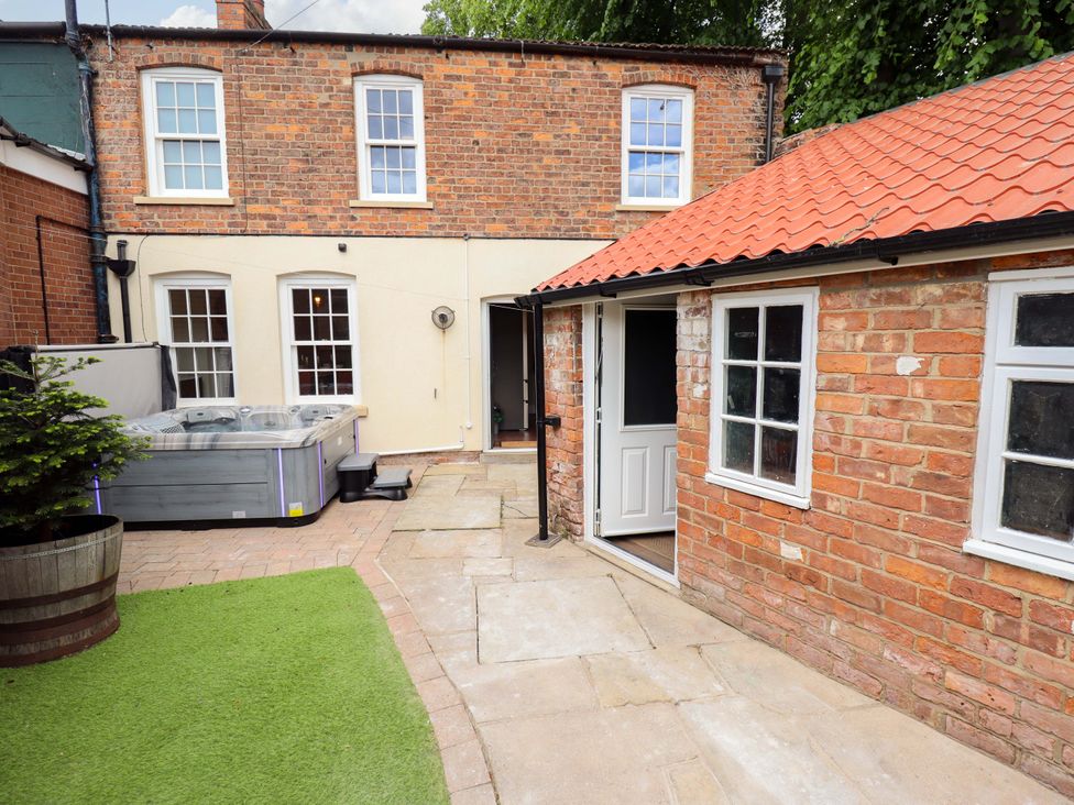 An outdoor area with a hot tub and brick building at 35 Wrawby Street Brigg