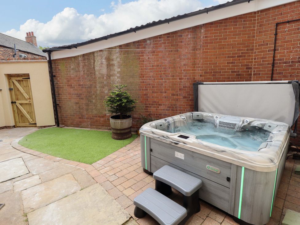 A garden with a hot tub and steps at 35 Wrawby Street Brigg