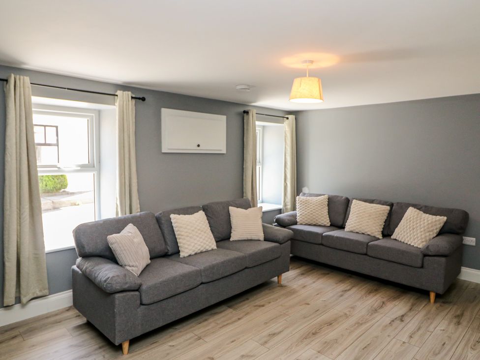 A living room with sofas and windows at Abinas in Kenmare
