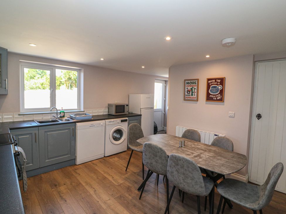 A kitchen with a table and chairs at Abinas in Kenmare
