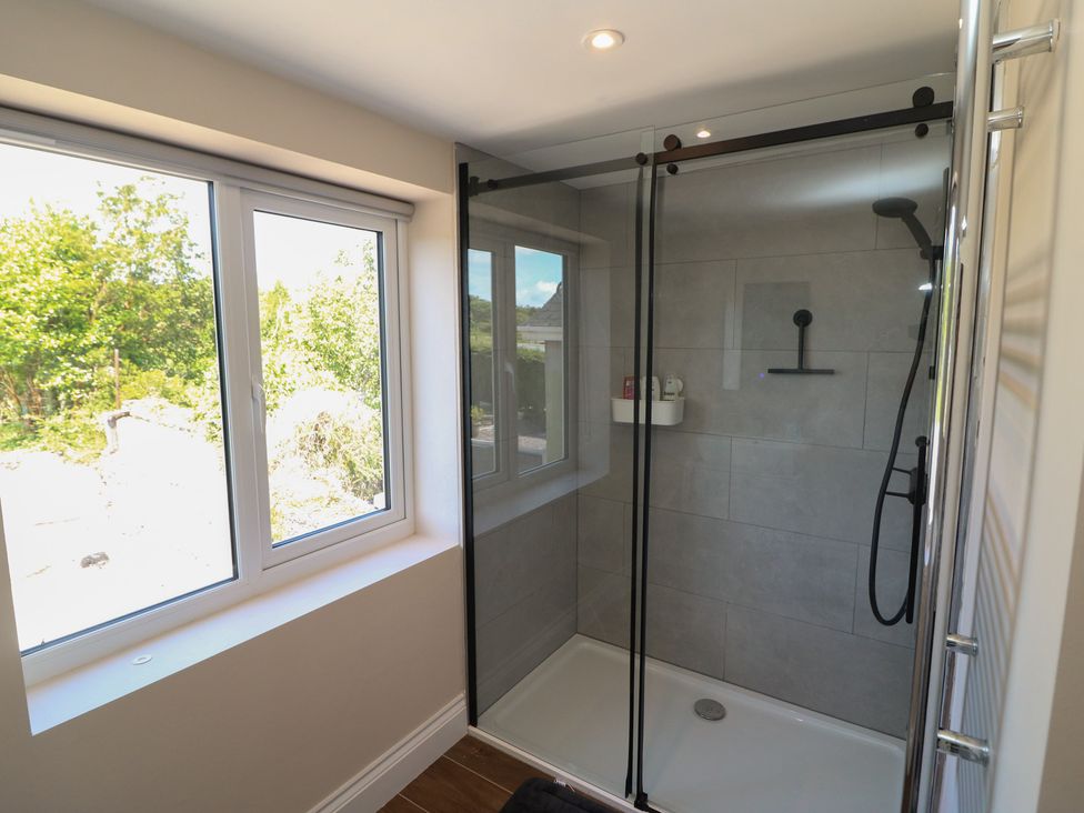 A bathroom with a shower and a window at Abinas in Kenmare