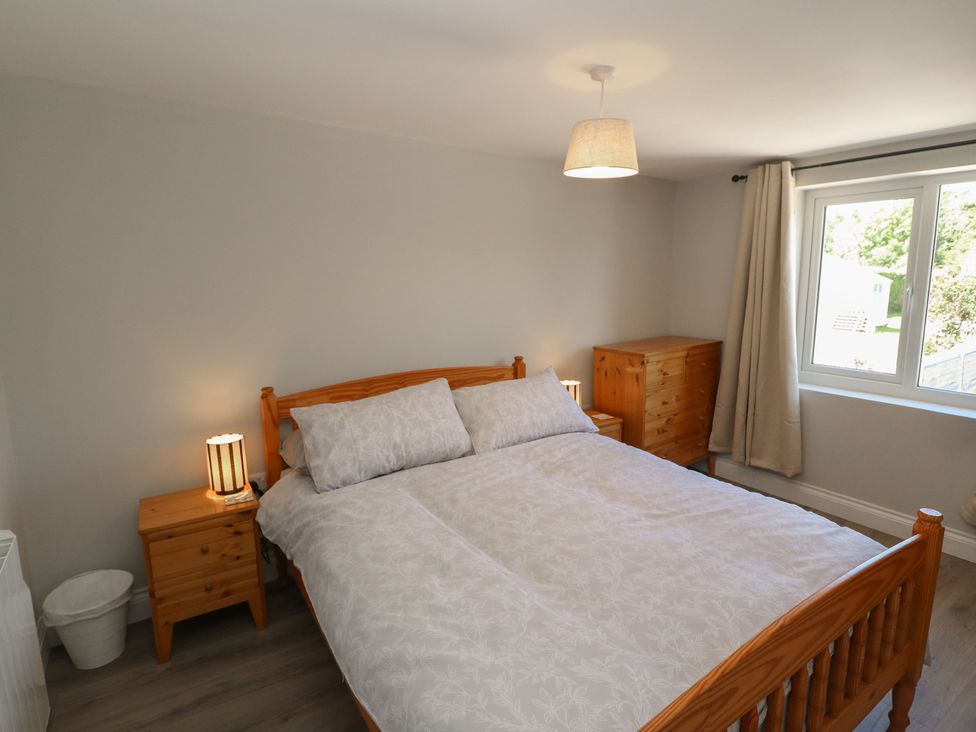 A bedroom with a bed and side tables at Abinas in Kenmare