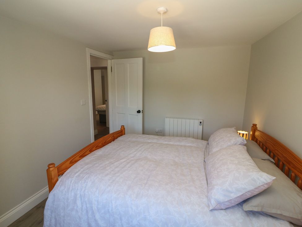 A bedroom with a bed and door at Abinas in Kenmare