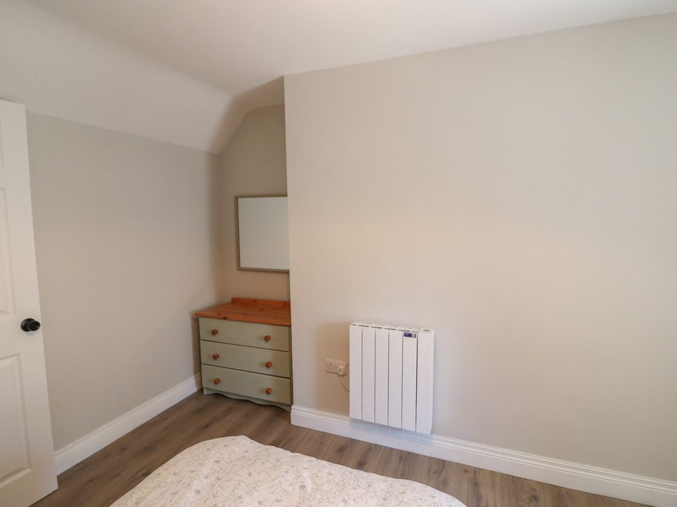 A bedroom with a dresser and mirror at Abinas in Kenmare