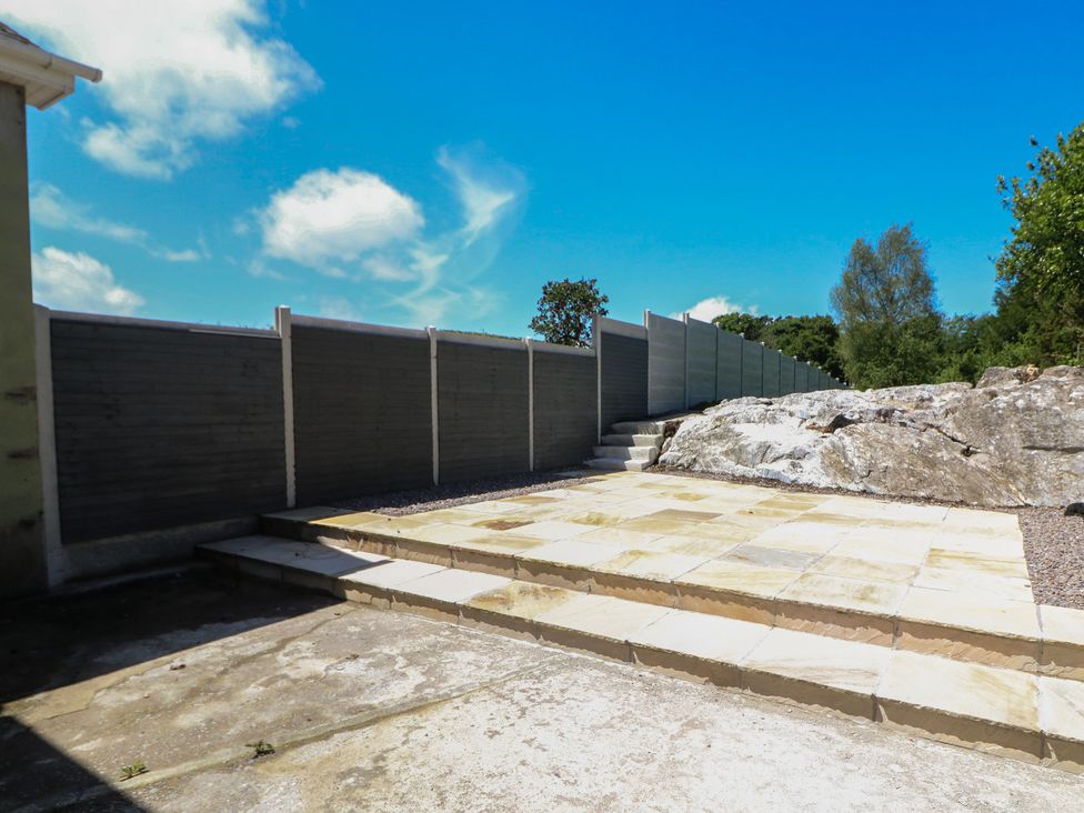 An outdoor space with a patio and stone steps at Abinas in Kenmare