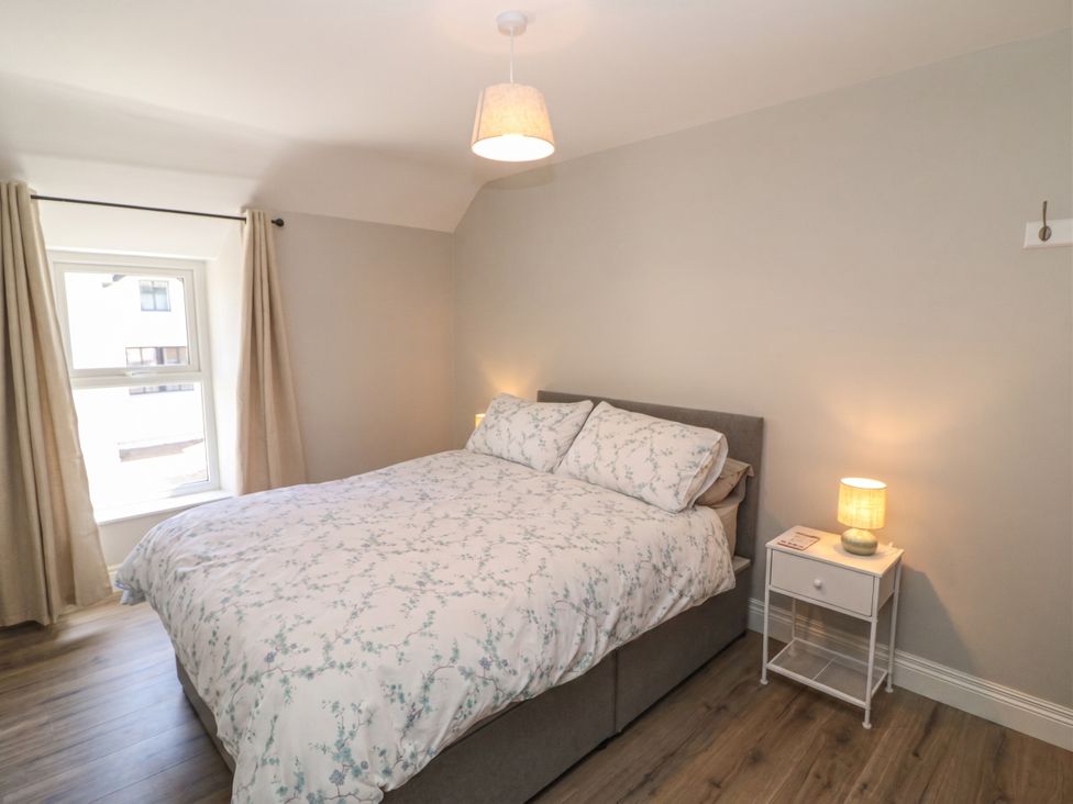 A bedroom with a bed and nightstand at Abinas Kenmare