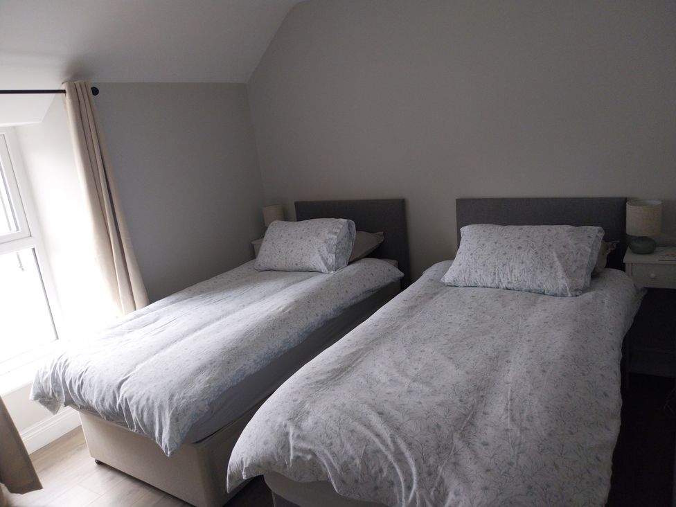 A bedroom with two single beds and bedside tables at Abina's, Kenmare, County Kerry