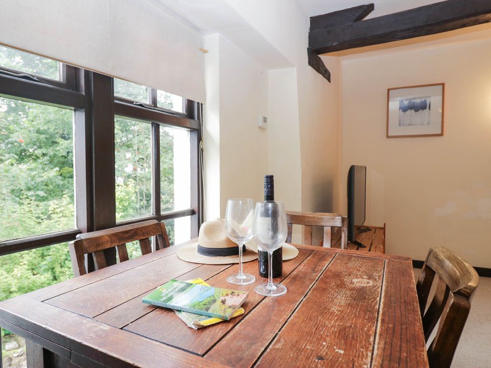 A dining room with a table and chairs at Flat 4 Grasmere Lodge in Ambleside