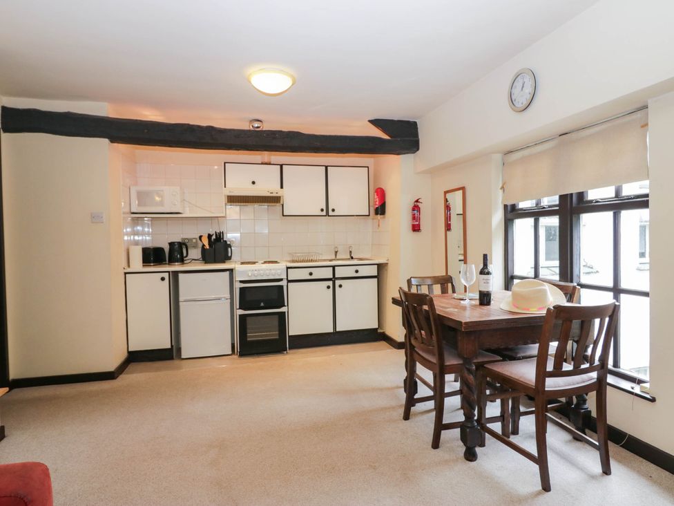 A kitchen with a dining table and chairs at Flat 4 Grasmere Lodge Ambleside