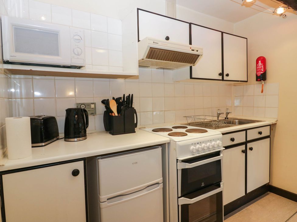 A kitchen with stove and sink at Flat 4 Grasmere Lodge in Ambleside