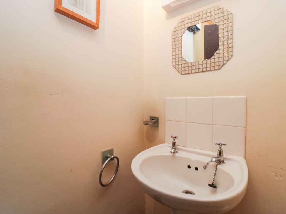 A bathroom with a sink and mirror at Flat 4 Grasmere Lodge in Ambleside