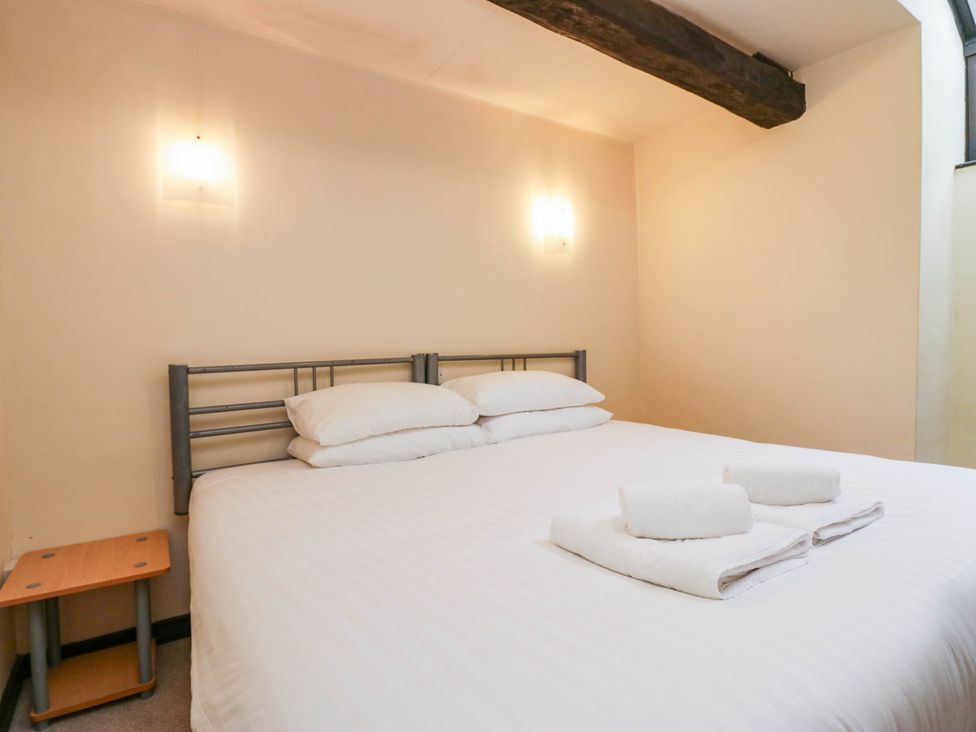 A bedroom with a bed and towels on top at Dunmail Raise, Grasmere Lodge Grasmere