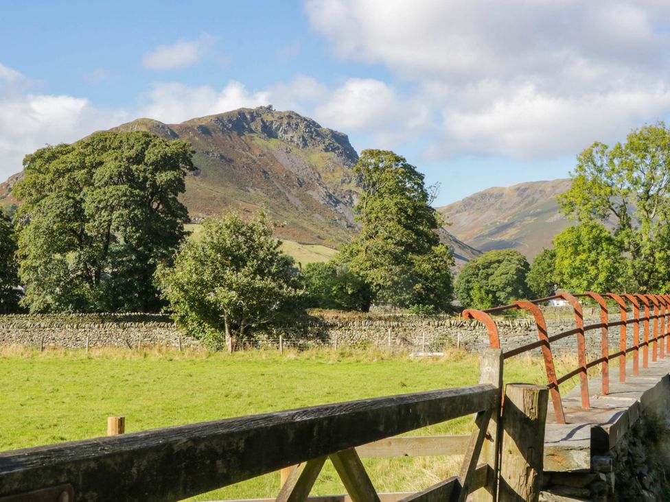 A view of mountains and trees with a fence in Dunmail Raise, Grasmere Lodge Grasmere