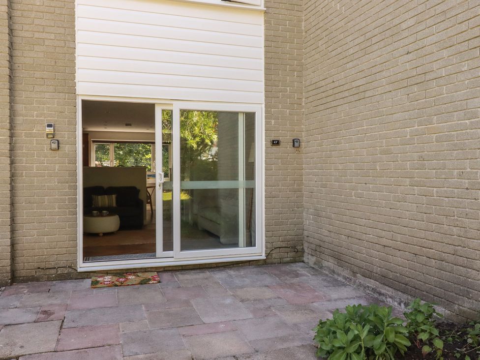 An outdoor area with a glass door and window at 67 Manor Villas in Newquay