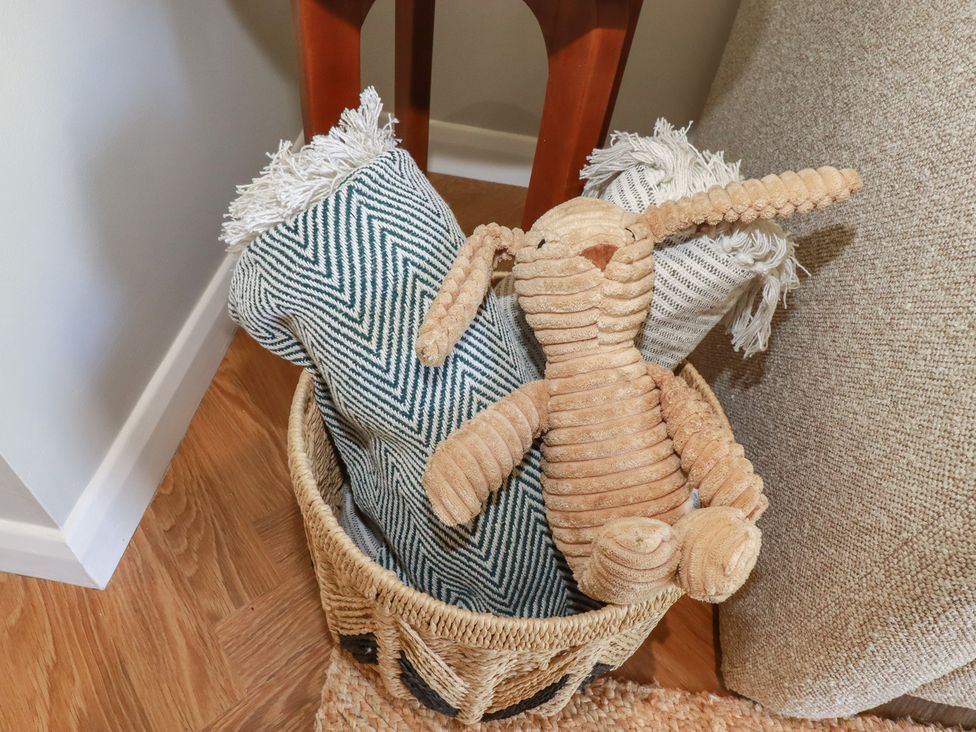 A basket with a blanket and a stuffed animal at 67 Manor Villas in Newquay