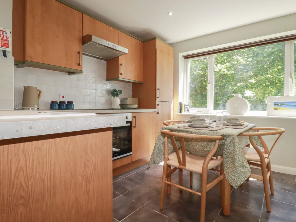 A kitchen with a dining table set for meal at 67 Manor Villas in Newquay