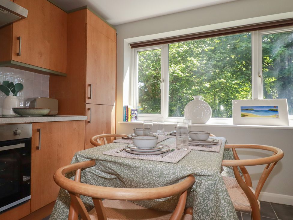 A kitchen with a dining table and window at 67 Manor Villas Newquay