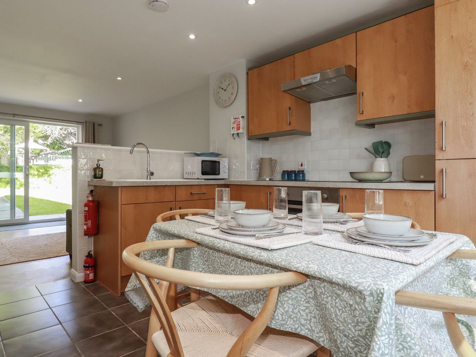 A kitchen with a dining table and chairs at 67 Manor Villas in Newquay