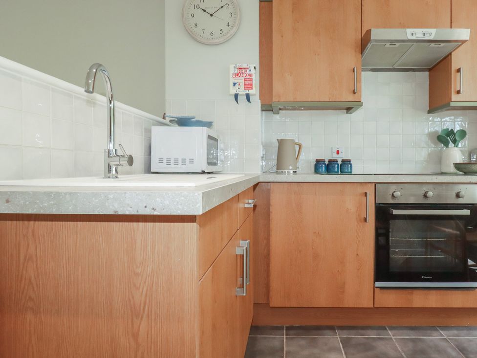 A kitchen with cabinets and appliances at 67 Manor Villas in Newquay