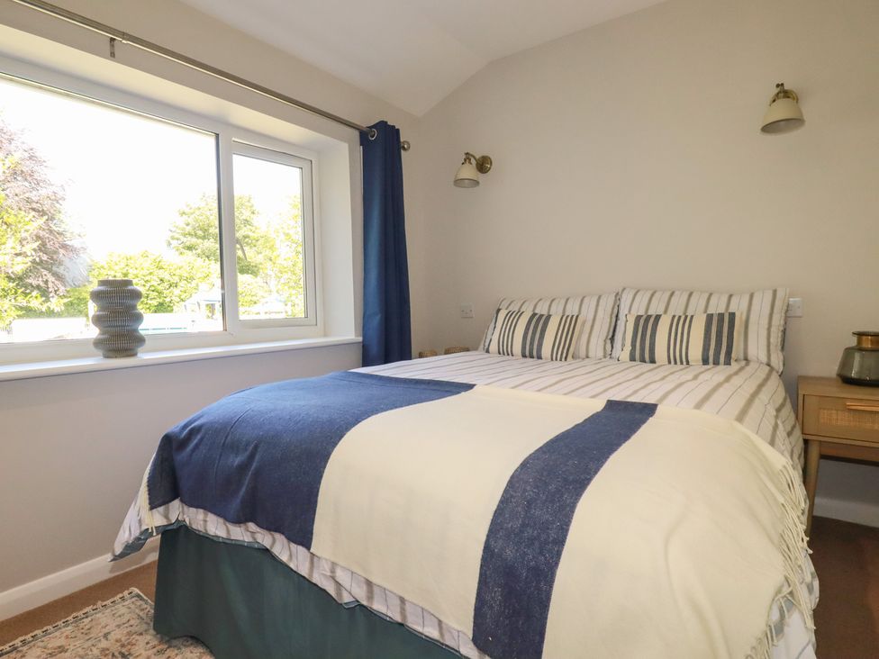 A bedroom with a bed and window at 67 Manor Villas in Newquay