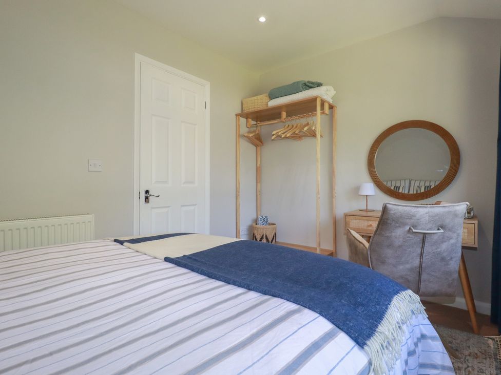 A bedroom with a bed and a desk at 67 Manor Villas in Newquay